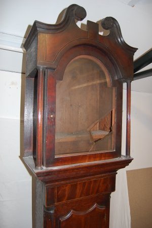 Broken glass on the front of the Grandfather Clock