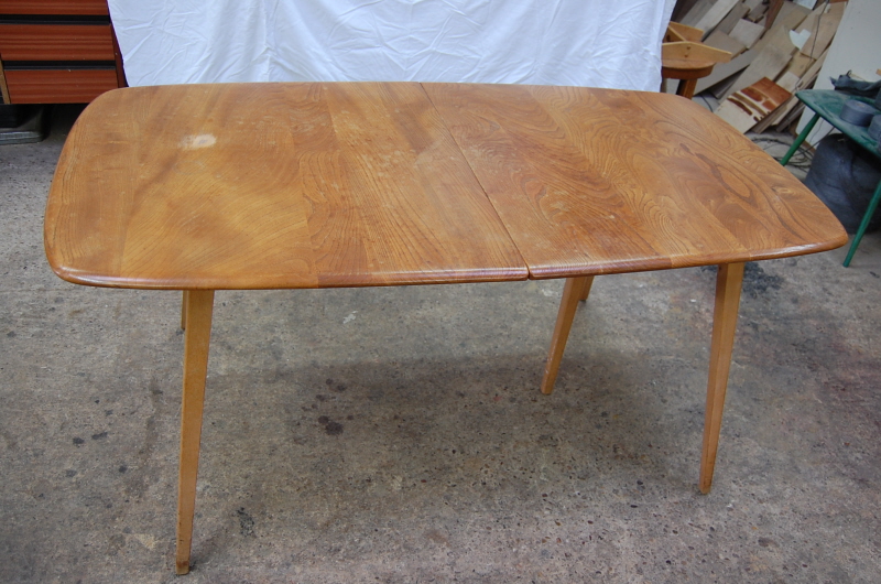 The table's polish was very worn and there was a nasty chunk that had been chipped out of the the table top.